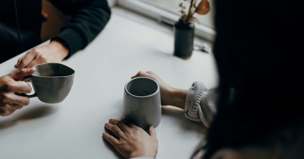 hands on table drinking coffee
